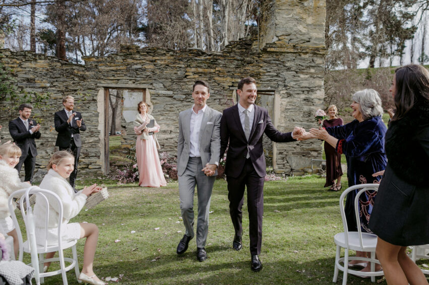 Liam and Steve just married, walking back down the aisle grabbing mums hand on the way