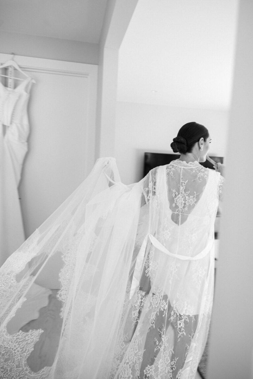 Bride candidly carrying her dress