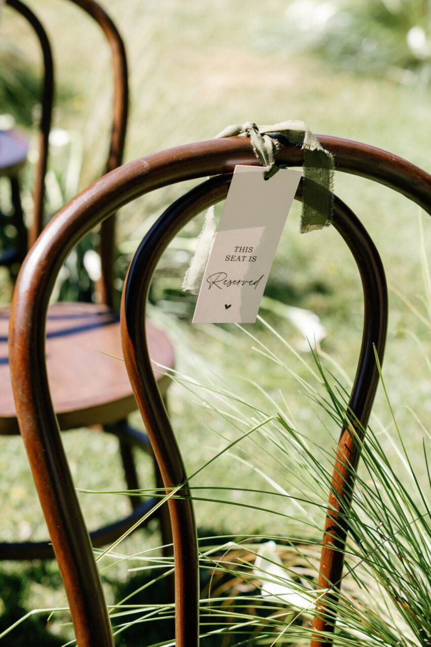 close up of a reserved sign on a chair at the ceremony