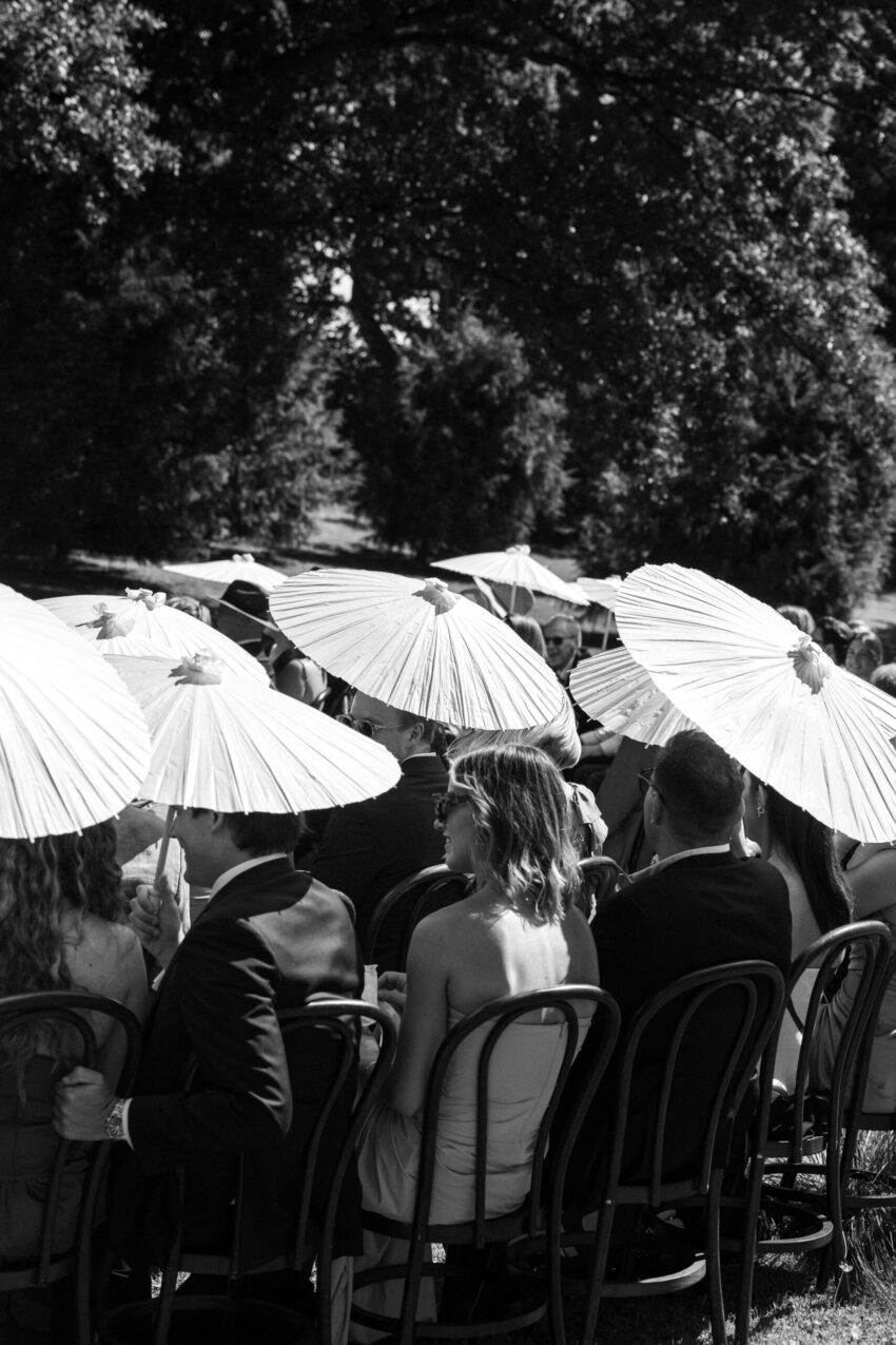 b&w of guests seated with parasols
