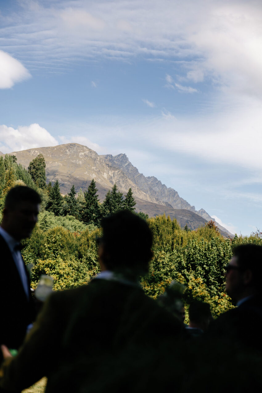 wide shot of guests with mountains in the background