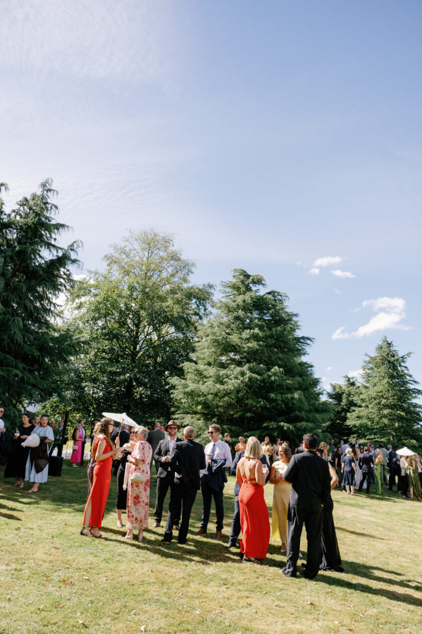 wide shot of guests mingling with mountains in the background