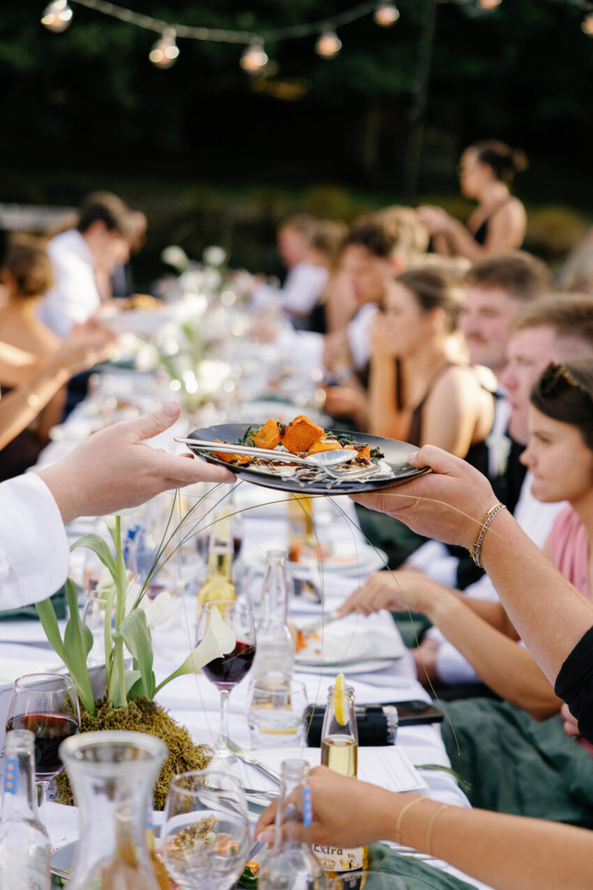 closeup of the dining table scene with guests sharing a plate of food