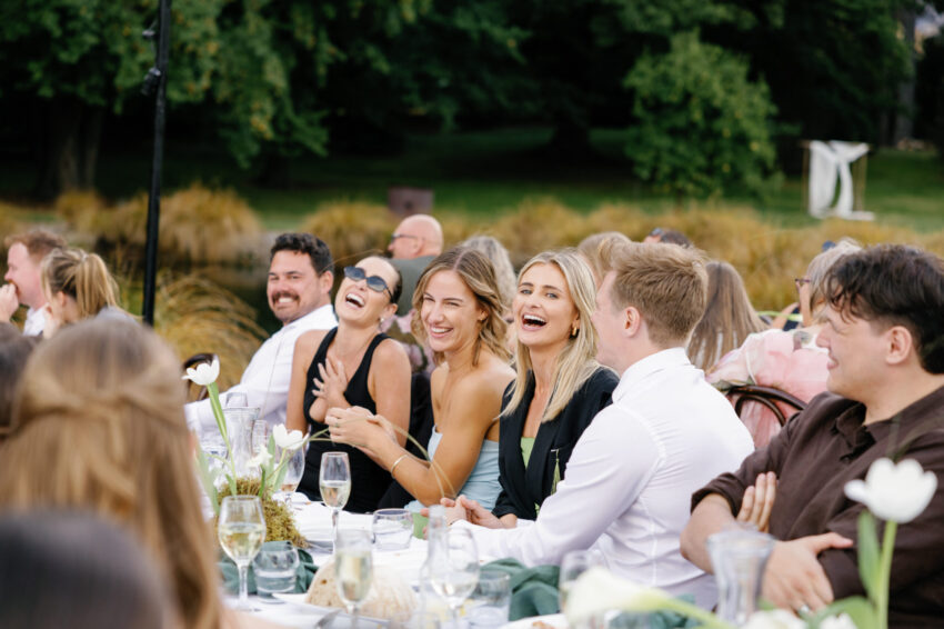 Guests laughing and having a great time at dinner