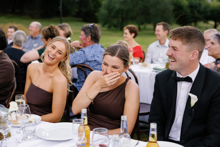 Guests laughing and having a great time at dinner
