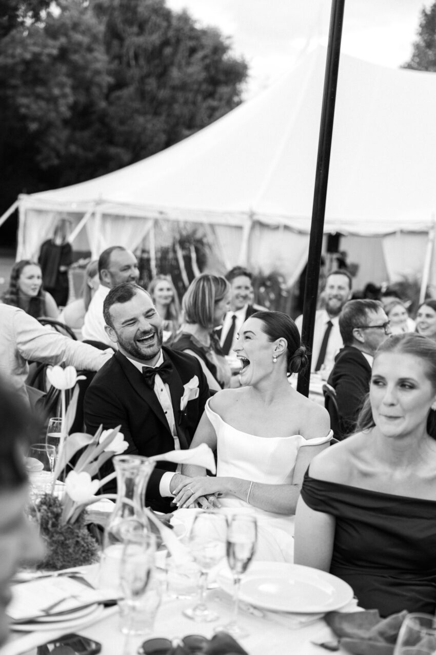 Bride and Groom laughing and having a great time at dinner