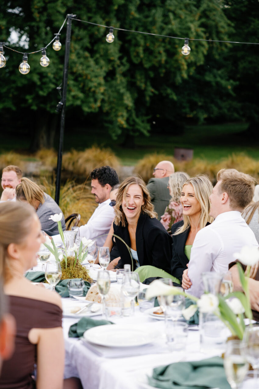 Guests laughing and having a great time at dinner