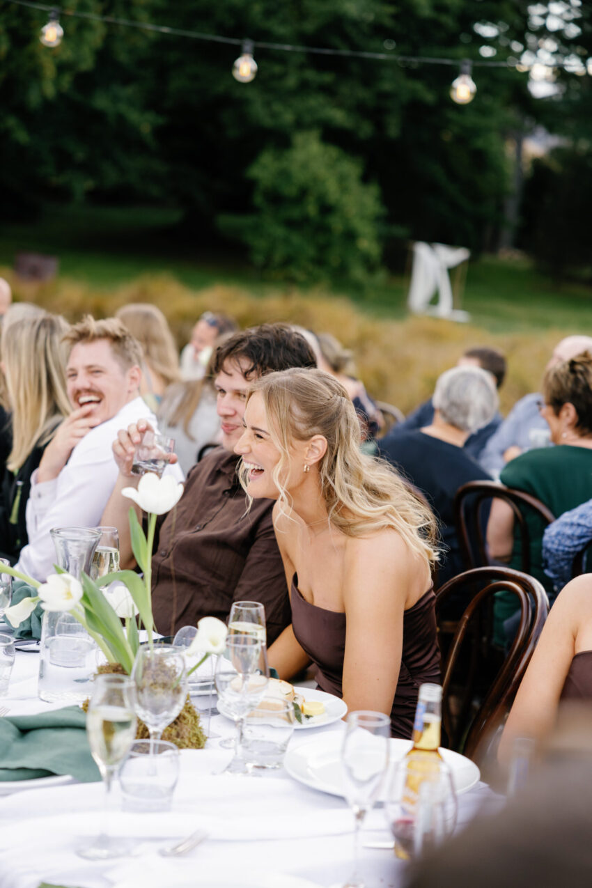Guests laughing and having a great time at dinner
