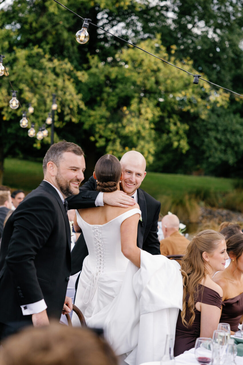 Groomsmen hugs the bride