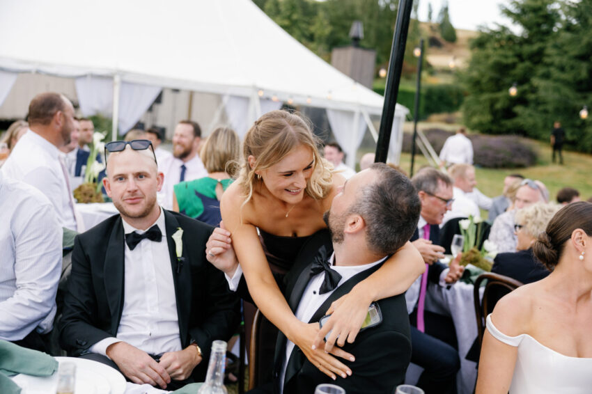 Bridesmaid hugs Groom