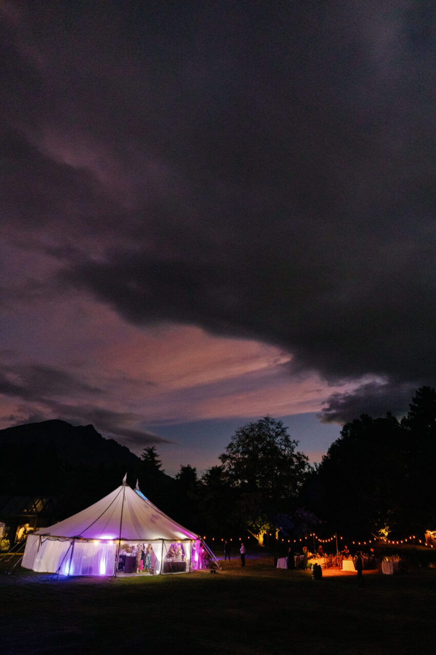 The scene at night, the tent glowing with party lights
