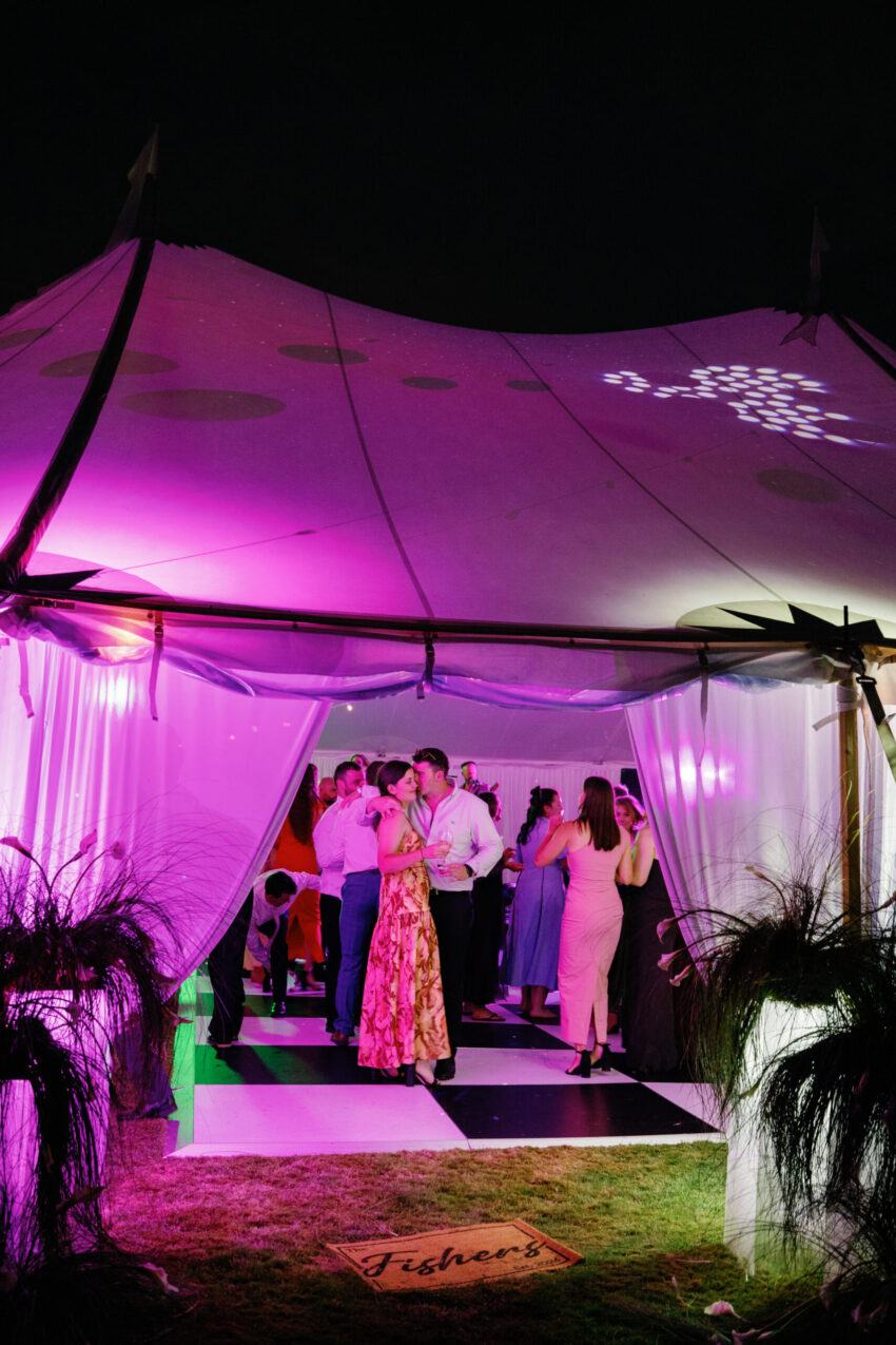 The tent at night through the doorway with guests inside