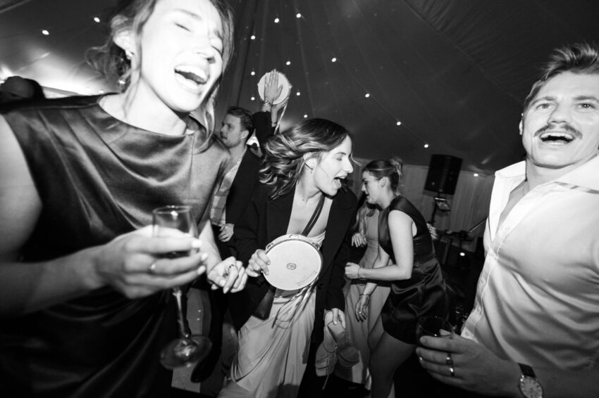 Guests having fun with tamborines on the dance floor